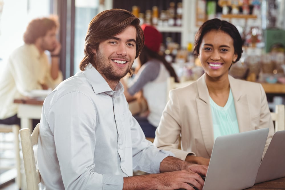 Man and woman using laptop during meeting in cafe-1